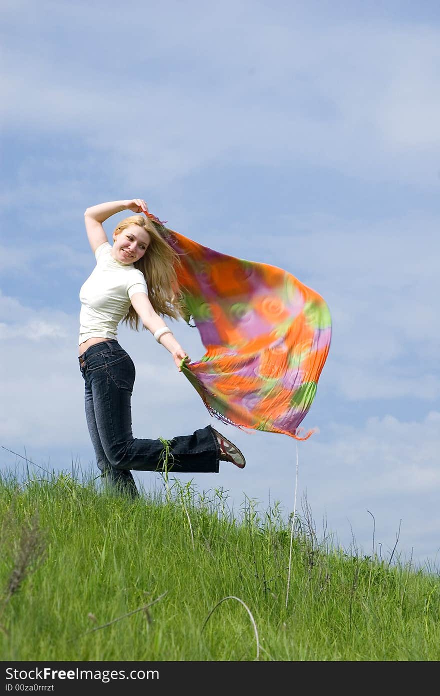 Girl with scarf stand on a wind