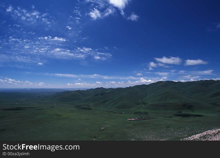 The grassland with clouds in the sky.