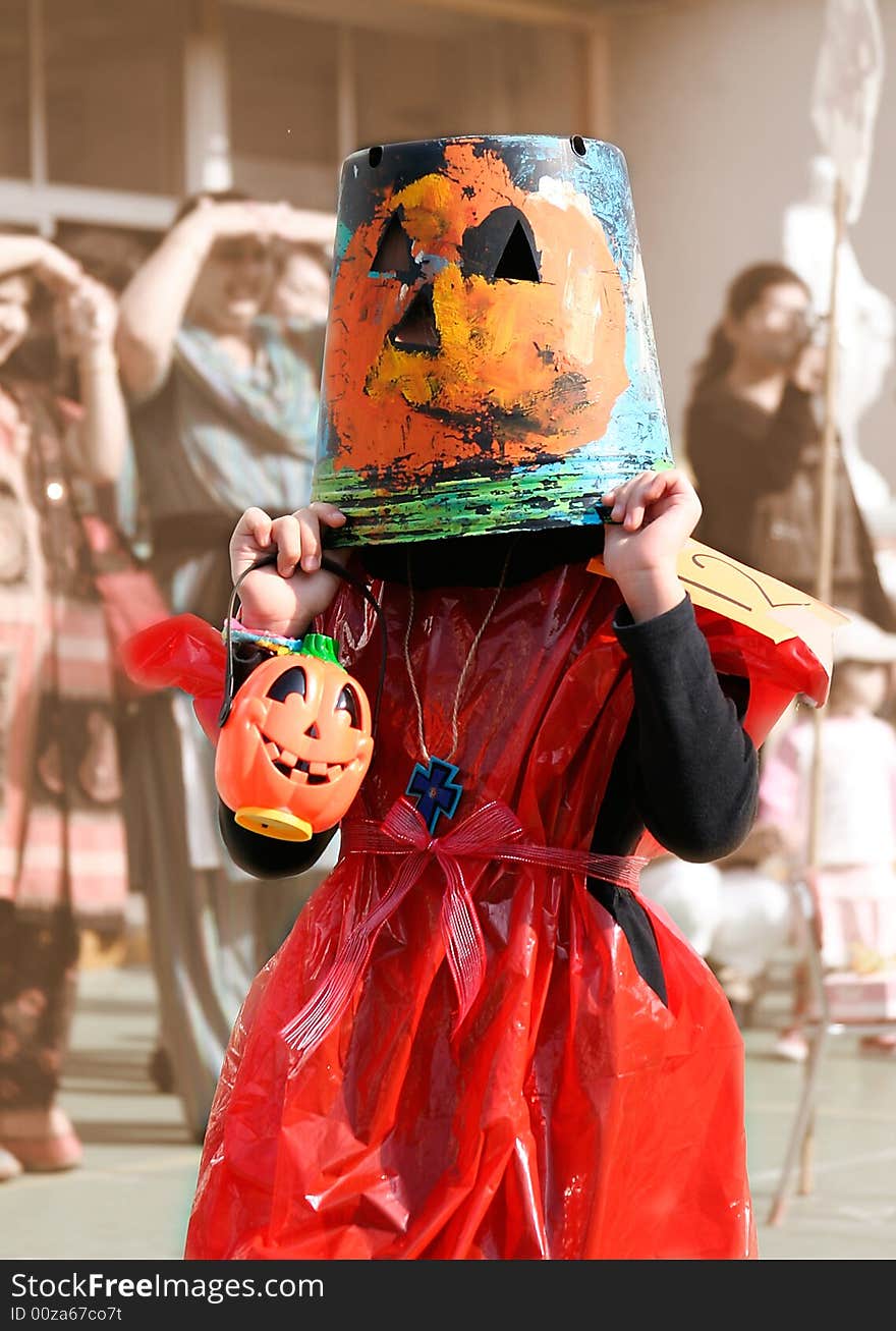 Child with pumpkin pale on head