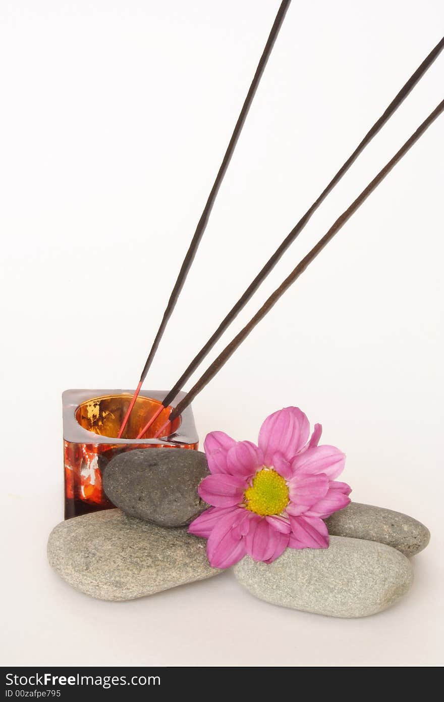 Three incense sticks and pebbles in white background. Three incense sticks and pebbles in white background