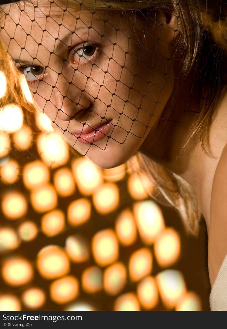 Retro portrait of young lady with veil over mottled lighting background