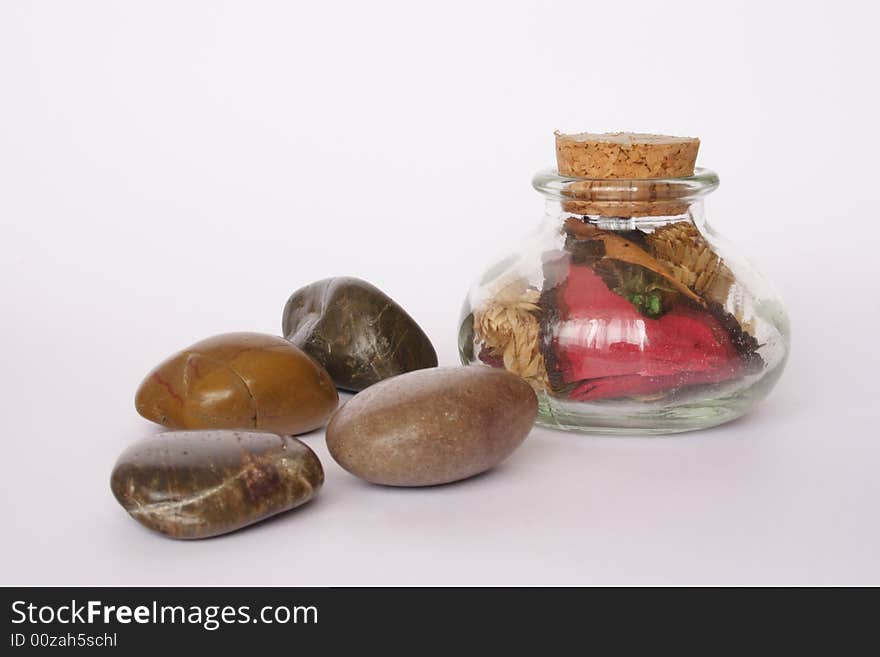 Pebbles and small  bottle with scented flowers. Pebbles and small  bottle with scented flowers