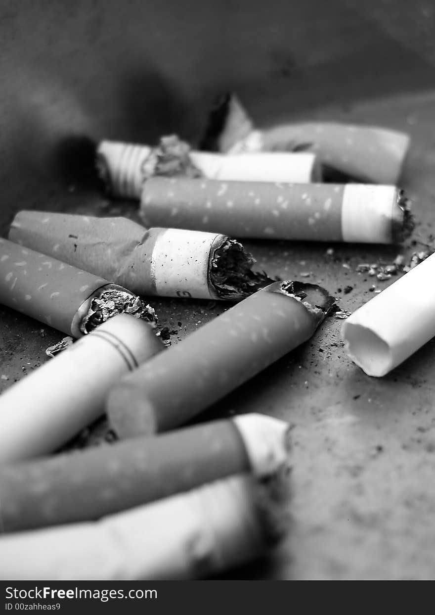 Black and White Close-Up of Ashtray with Cigarettes. Black and White Close-Up of Ashtray with Cigarettes