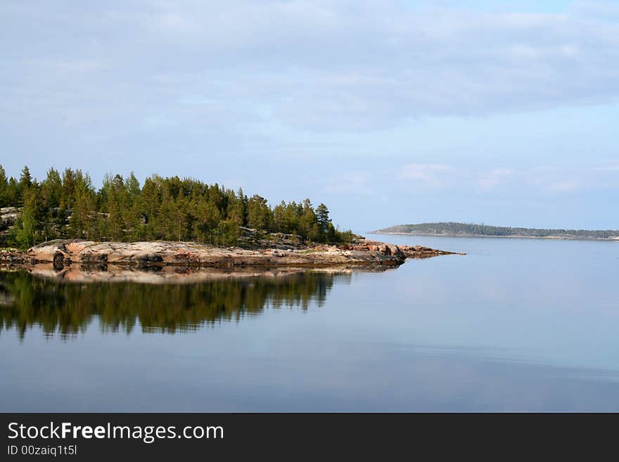 Cape and island in a quite summer sea