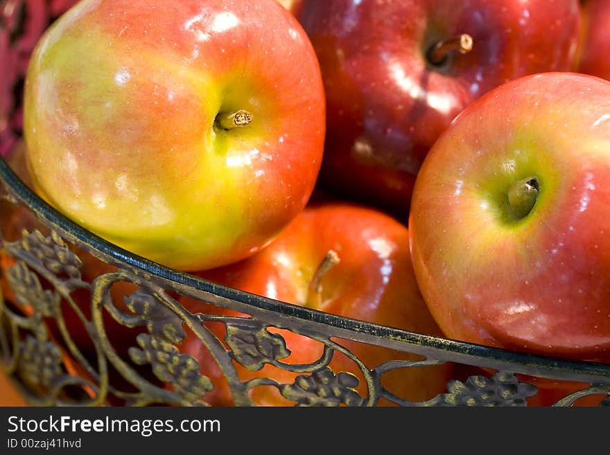 Delicious fresh red apples in wrought iron basket. Delicious fresh red apples in wrought iron basket