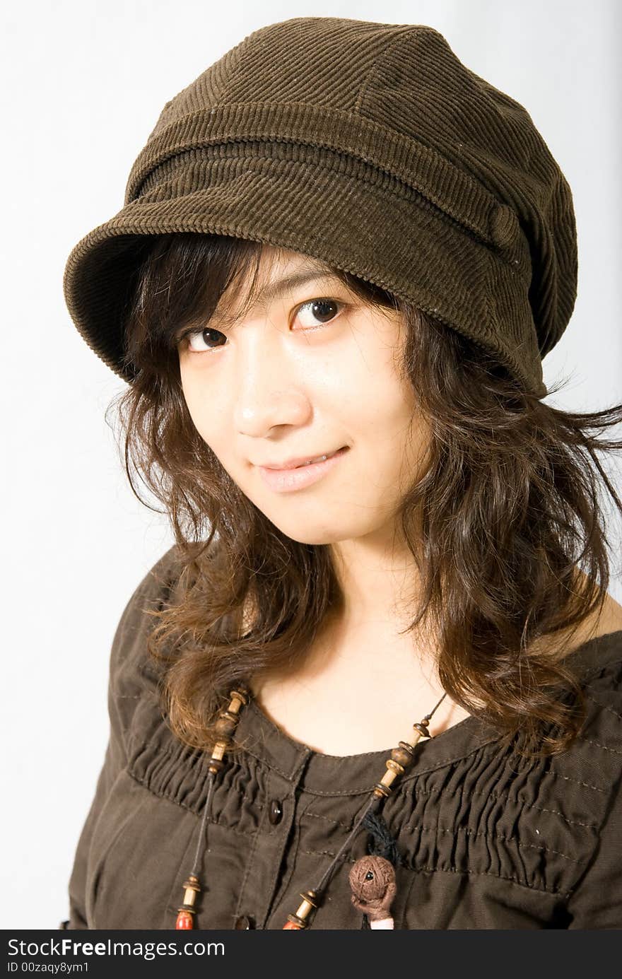 A cute asian girl wears a brown hat which fit her face and hair very well!. A cute asian girl wears a brown hat which fit her face and hair very well!