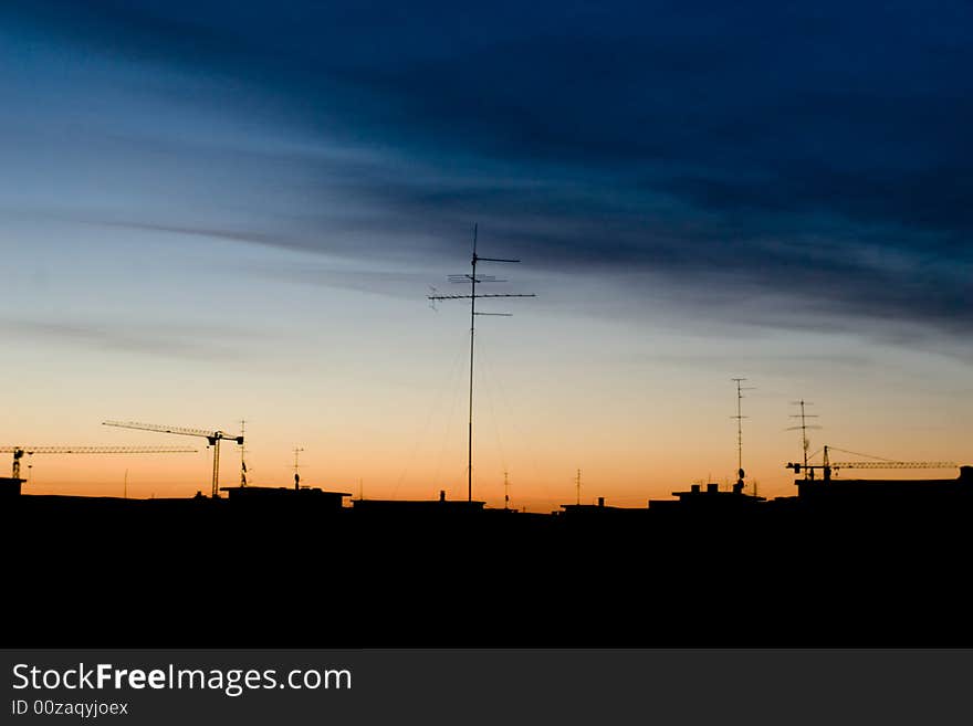 Flat city lines with tv antennas and cranes