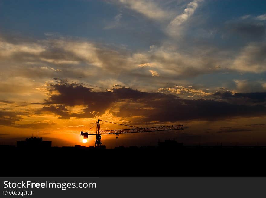 Summer sunset over city construction site. Summer sunset over city construction site