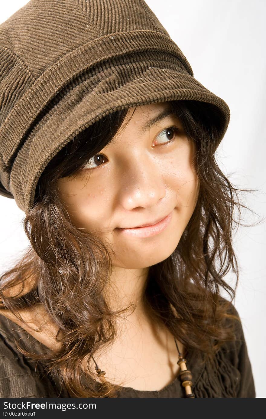 A cute asian girl wears a brown hat which fit her face and hair very well!. A cute asian girl wears a brown hat which fit her face and hair very well!