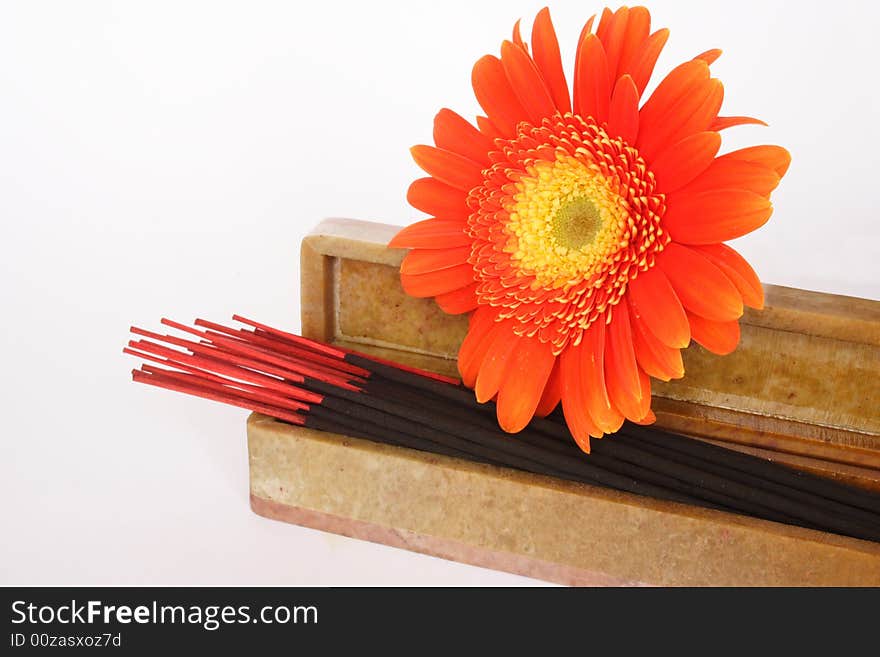 Incense sticks in their box and flower in white background. Incense sticks in their box and flower in white background