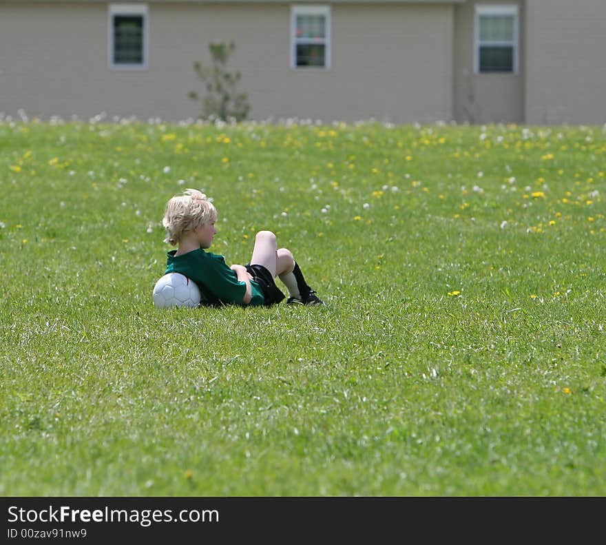 Young boy waiting for the sign to go in and play soccer. Young boy waiting for the sign to go in and play soccer