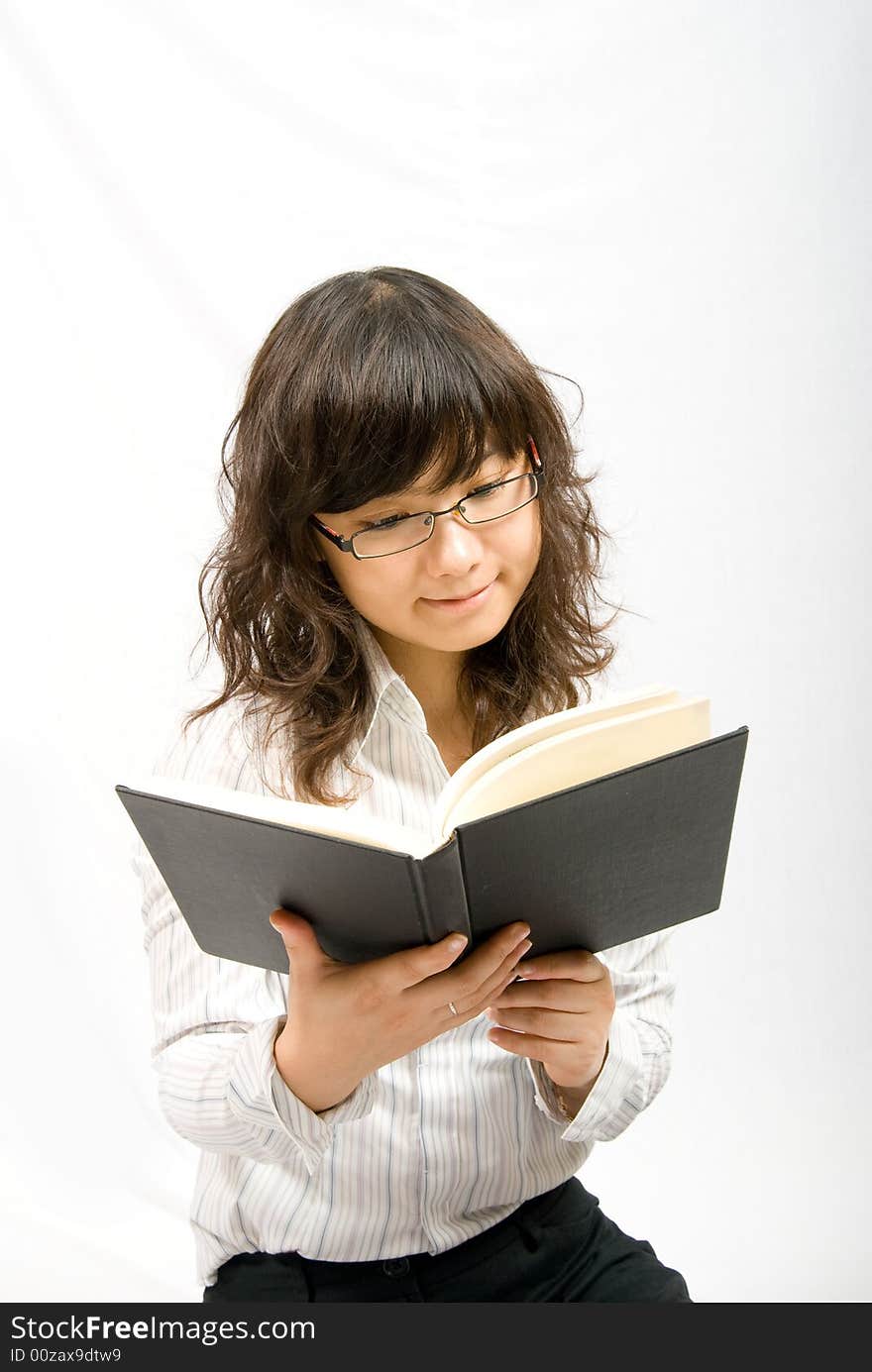 An asian female is reading a book. Portrait in white background, easy to cut out. An asian female is reading a book. Portrait in white background, easy to cut out.