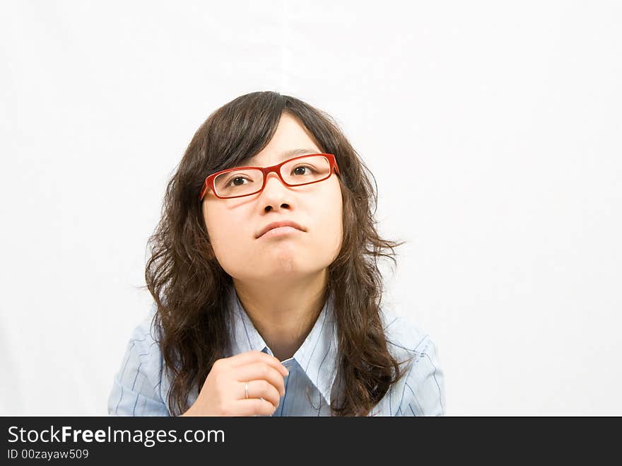 A very cute girl wearing red frame glass and light blue shirt is thinking something...