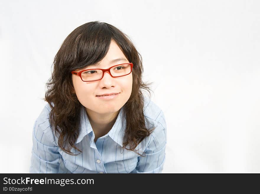 A very cute girl wearing red frame glass and light blue shirt is thinking something...