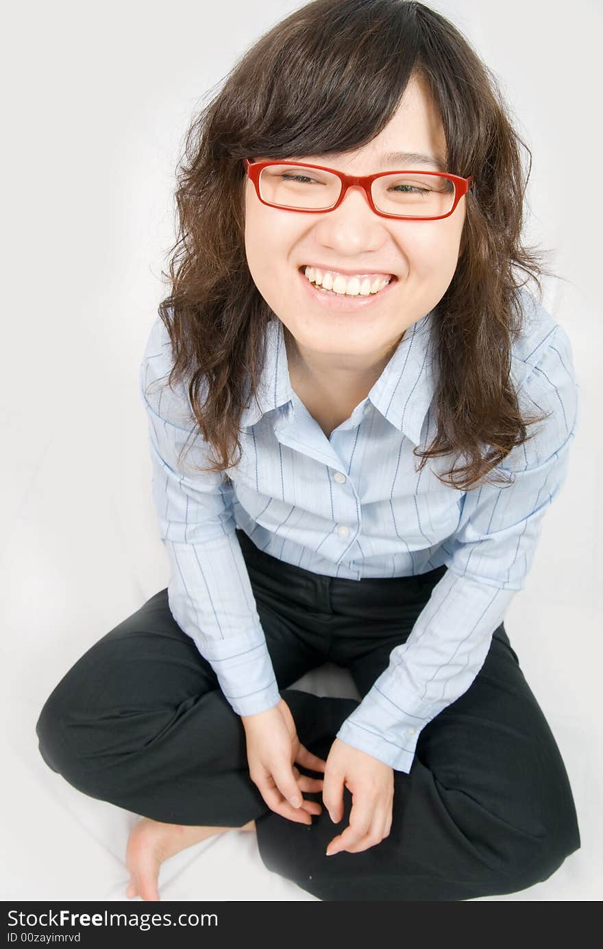 A asian girl is laughing happily. bared feet on white background. A asian girl is laughing happily. bared feet on white background