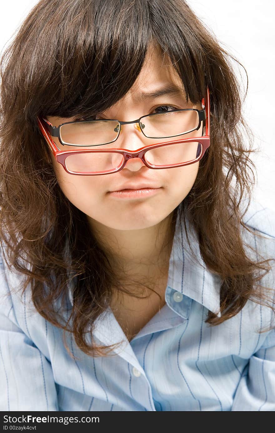 A cute girl in light blue shirt with two glasses in black and red frame.