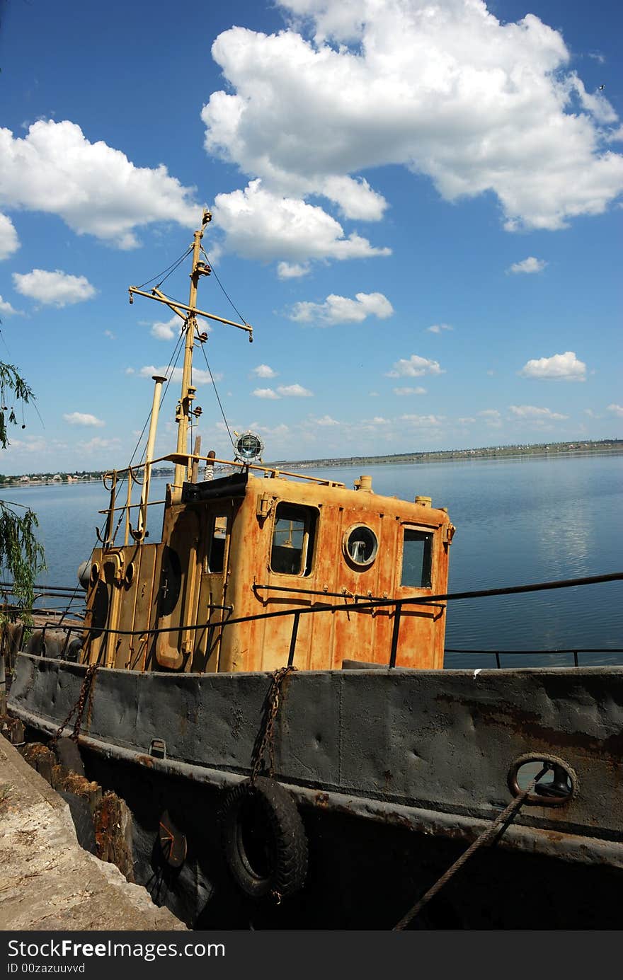 Panorama of calm river and old motor boat over cloudy sky. Panorama of calm river and old motor boat over cloudy sky