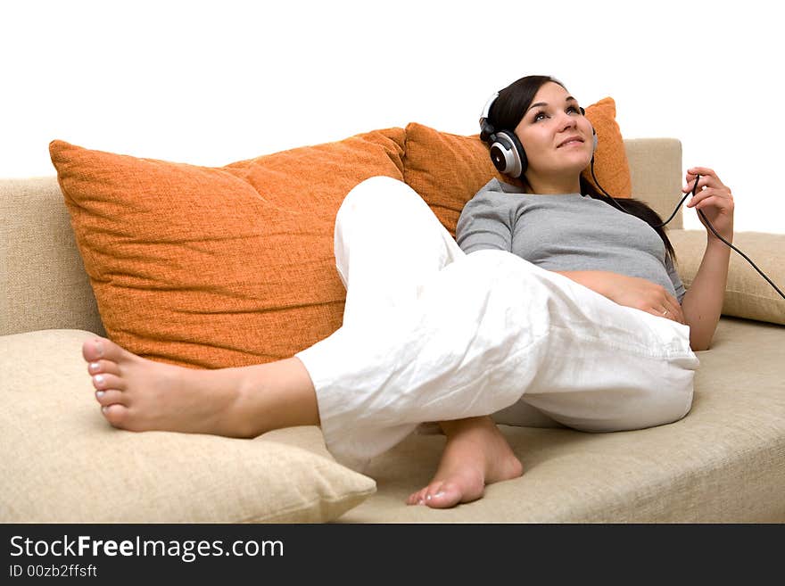 Attractive woman with headphones on sofa. Attractive woman with headphones on sofa