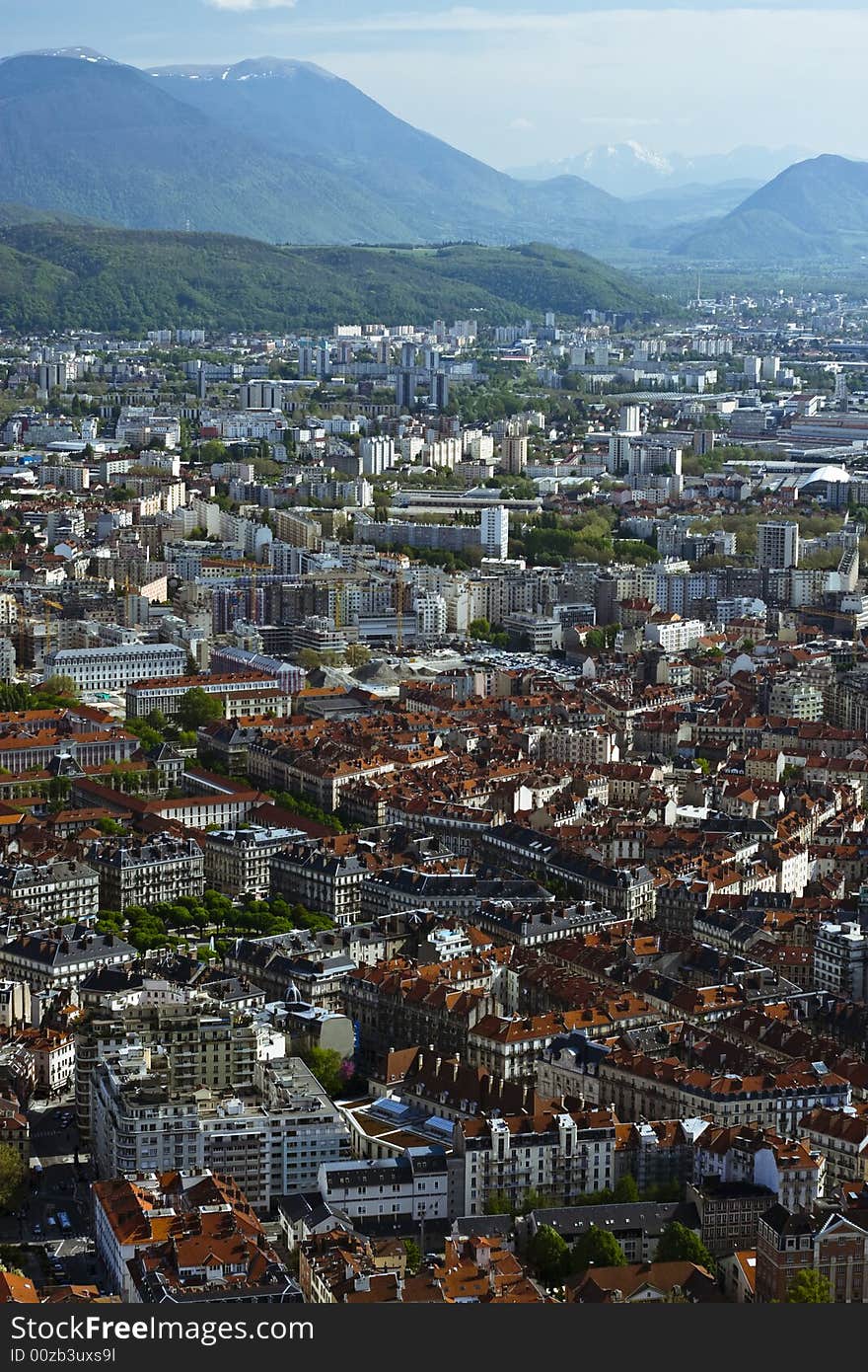 Wide angle view of Grenoble with Isere at the bottom and cloudy sky. Wide angle view of Grenoble with Isere at the bottom and cloudy sky.