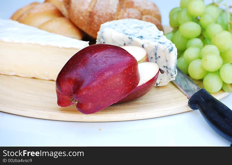 A shot of some bread,cheeses and fruit. A shot of some bread,cheeses and fruit