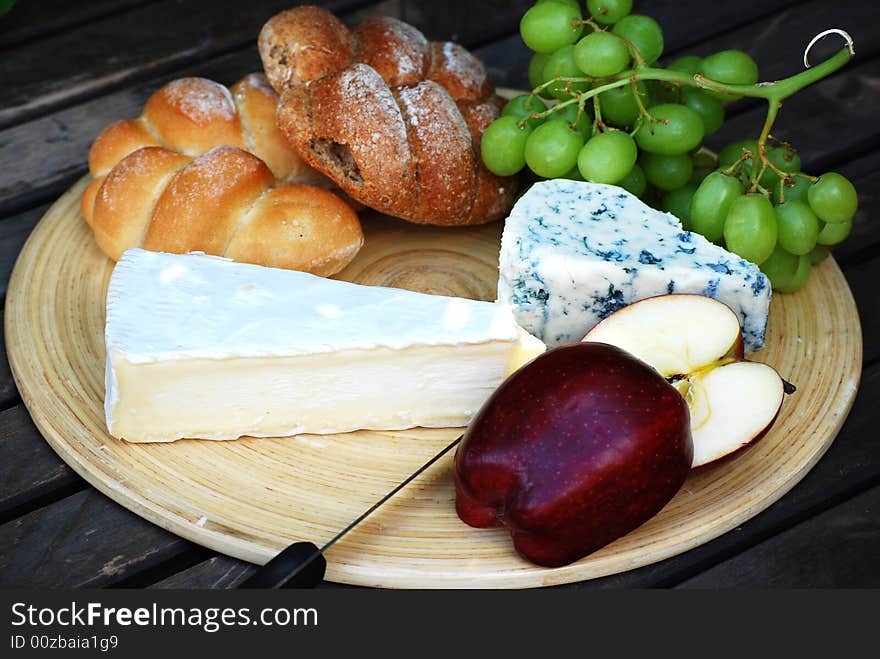 A shot of some bread,cheeses and fruit. A shot of some bread,cheeses and fruit