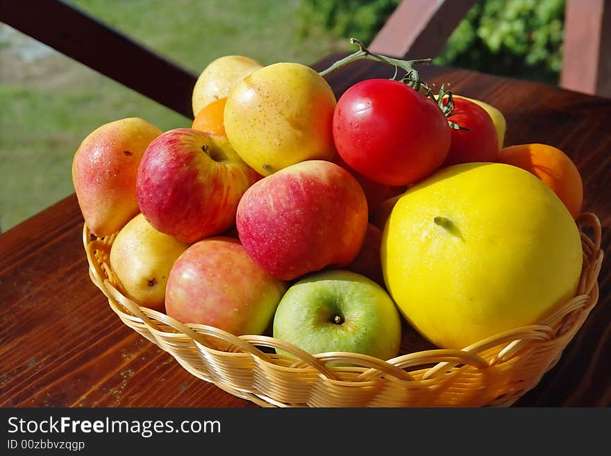 This is the picture of colorful, energy and vitamins full fruits close-up, with the water drops . Garden with wooden wall as background. This is the picture of colorful, energy and vitamins full fruits close-up, with the water drops . Garden with wooden wall as background.