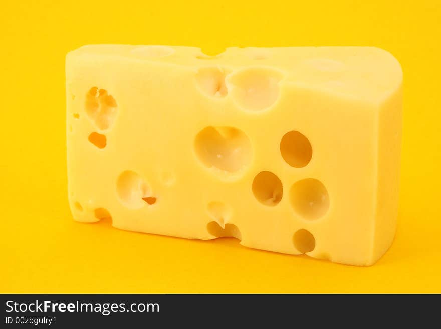 Cheese isolated on yellow background