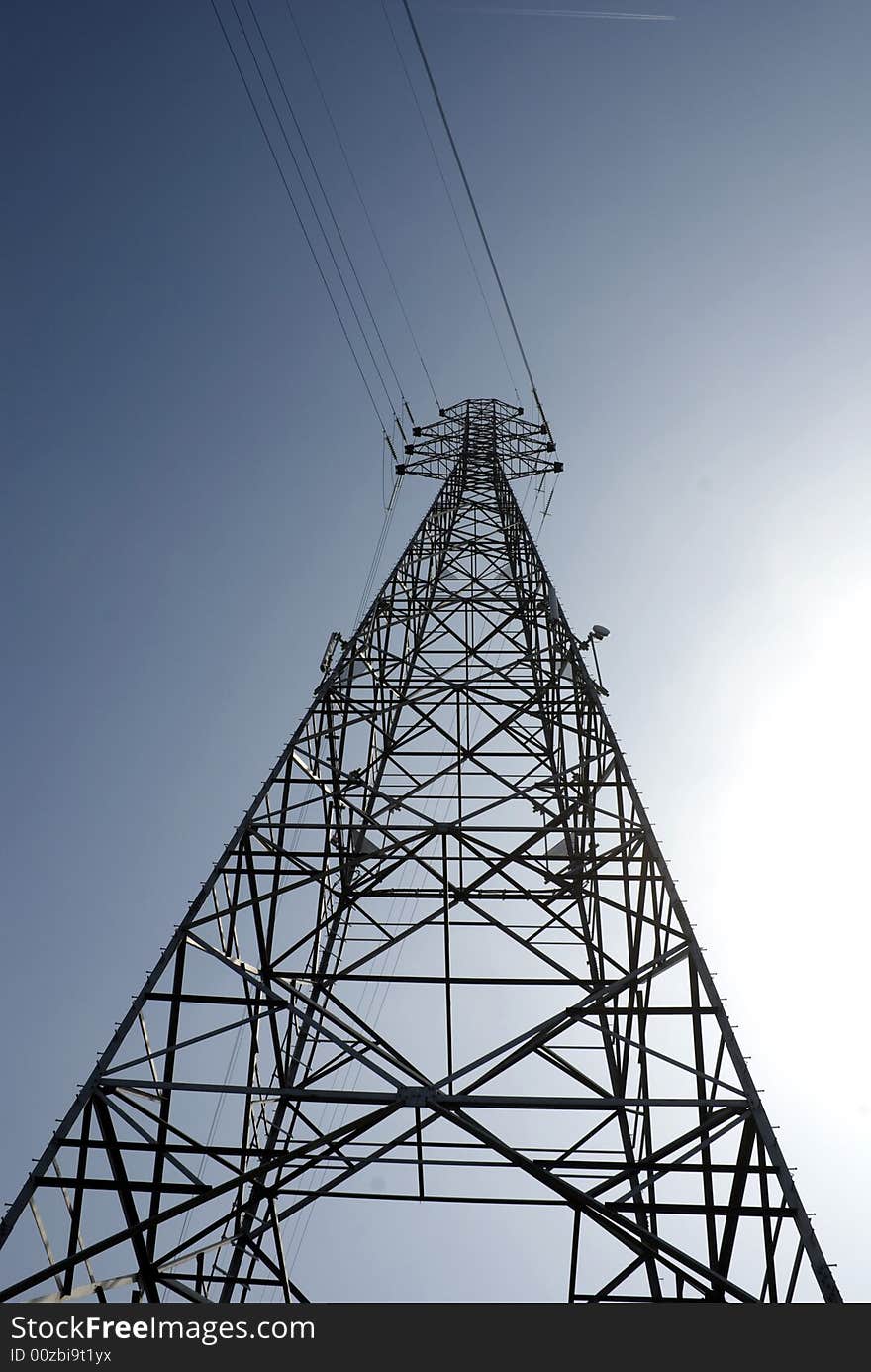 Impressive electric pylons transporting electricity through high tension cables. Impressive electric pylons transporting electricity through high tension cables.