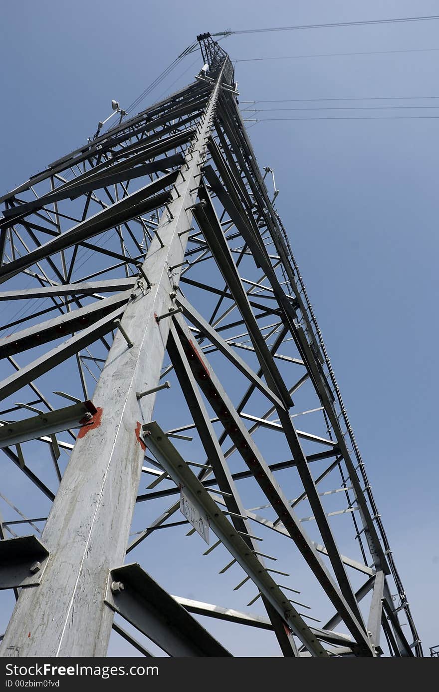 Impressive electric pylons transporting electricity through high tension cables. Impressive electric pylons transporting electricity through high tension cables.