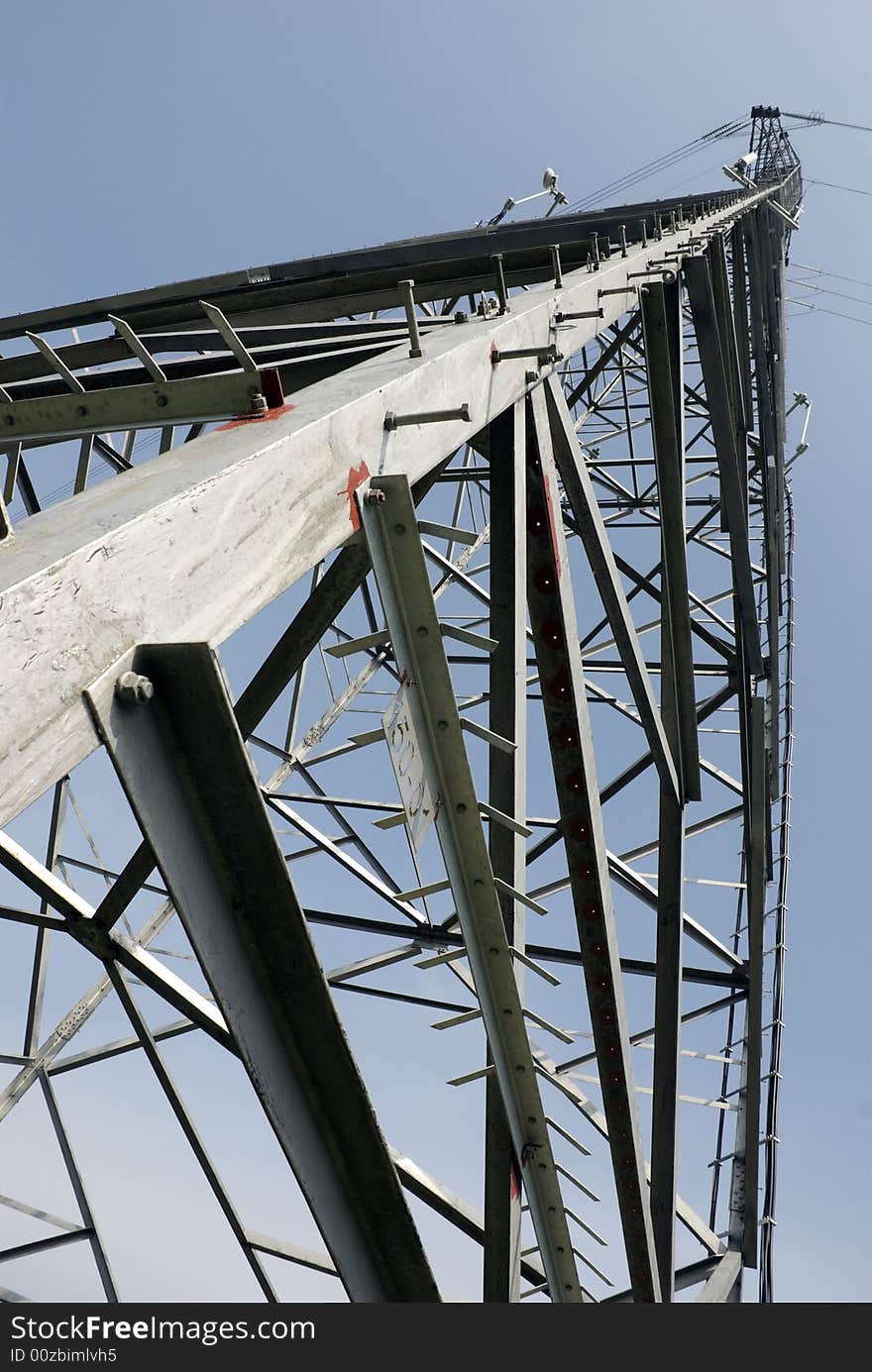 Impressive electric pylons transporting electricity through high tension cables. Impressive electric pylons transporting electricity through high tension cables.