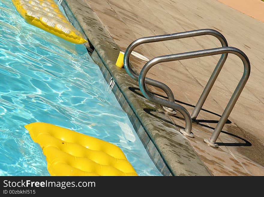 Bright yellow water mattress in the pool. Bright yellow water mattress in the pool