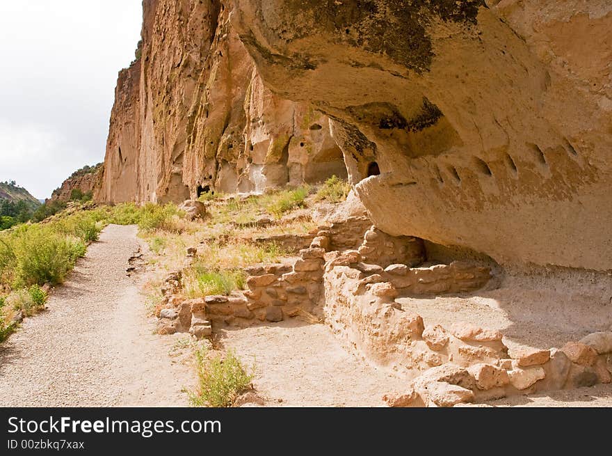 A view of the remains of a large native American Indian cliff dwelling in Bandelier National Monument, New Mexico. A view of the remains of a large native American Indian cliff dwelling in Bandelier National Monument, New Mexico.