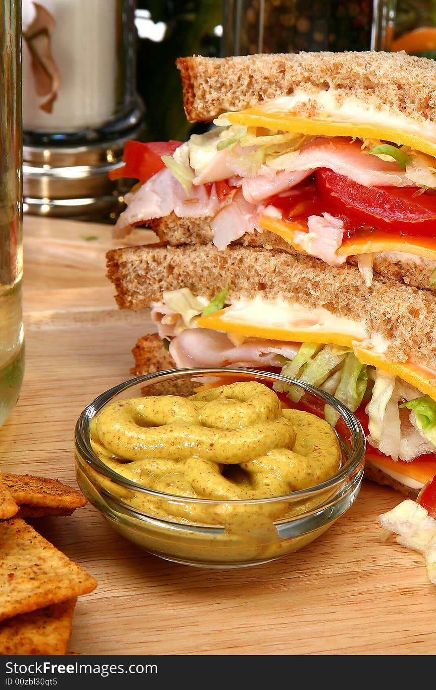 Whole wheat turkey sandwich with spicy mustard, crackers, tomato, cheese, lettuce. Whole wheat turkey sandwich with spicy mustard, crackers, tomato, cheese, lettuce.