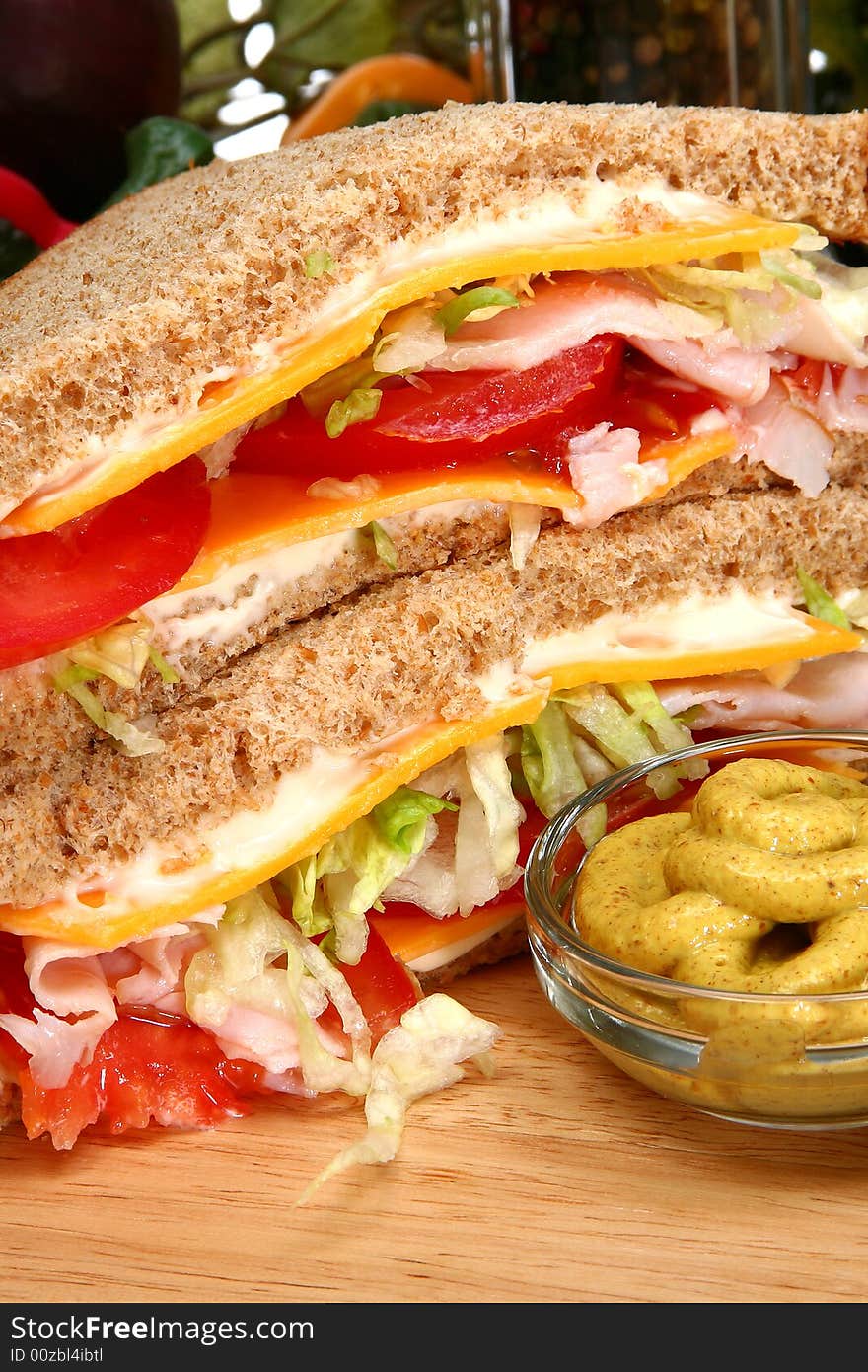 Whole wheat turkey sandwich with spicy mustard, crackers, tomato, cheese, lettuce. Whole wheat turkey sandwich with spicy mustard, crackers, tomato, cheese, lettuce.