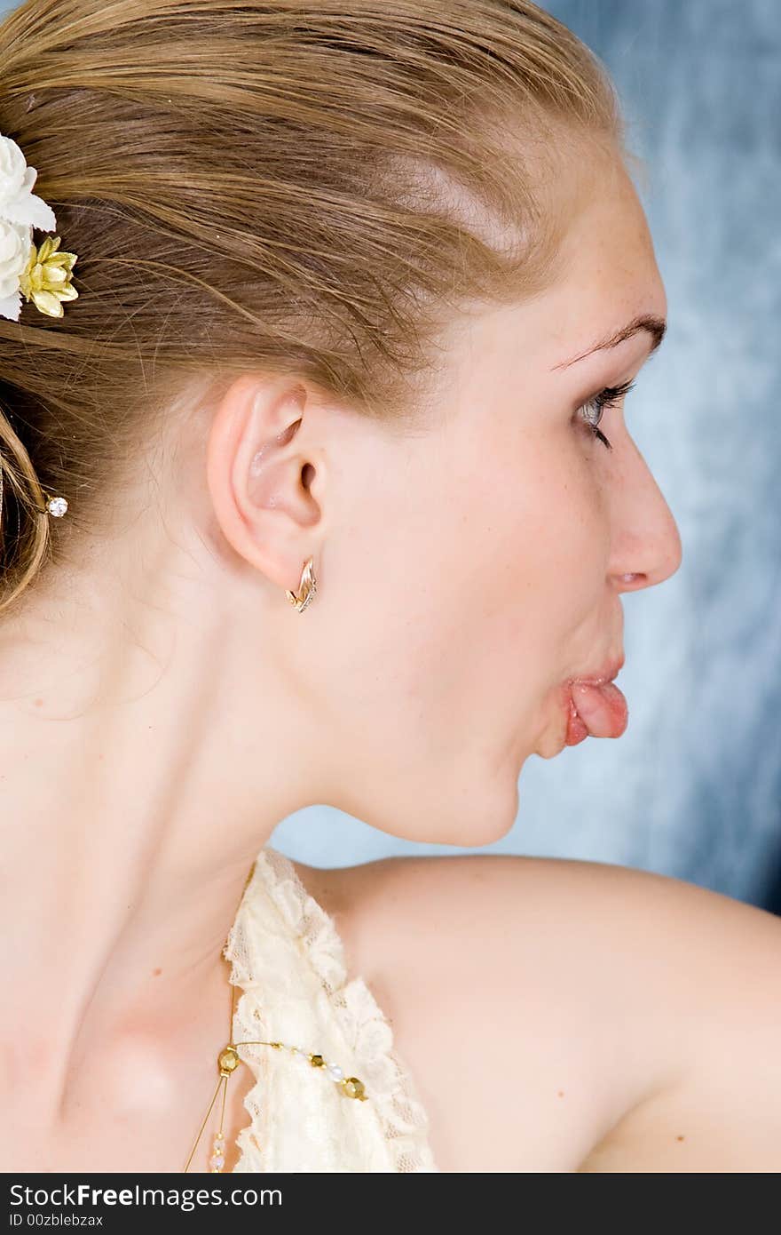 Wedding portrait of the bride. The girl puts out the tongue