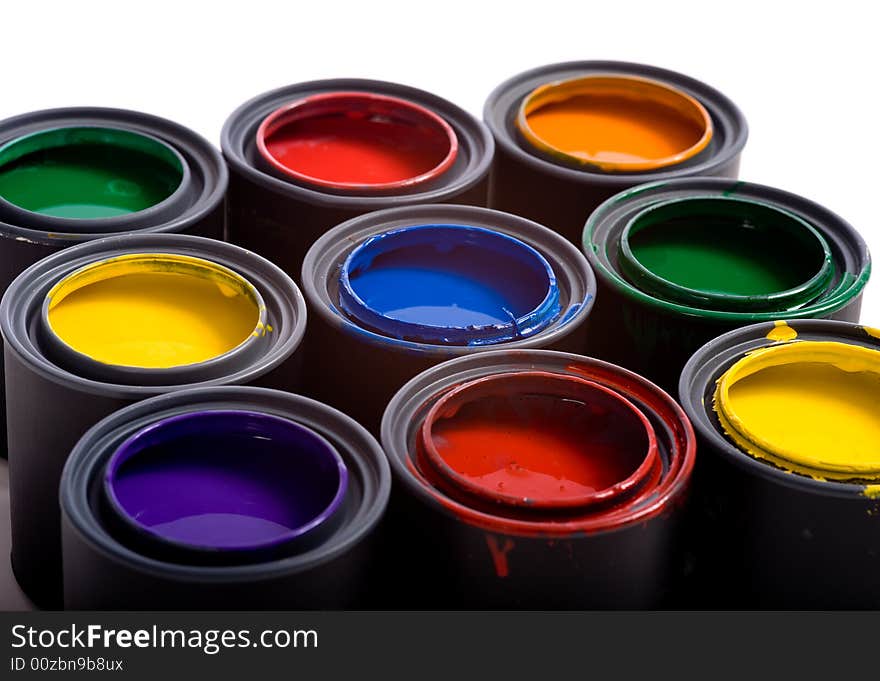 Cans of paint on a white background forming a colorful background. Cans of paint on a white background forming a colorful background