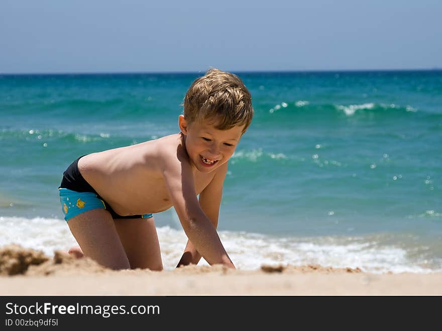 Joyful child play on coast of ocean. Joyful child play on coast of ocean