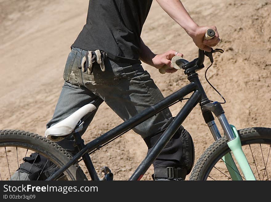 Biker with a bicycle in hands.