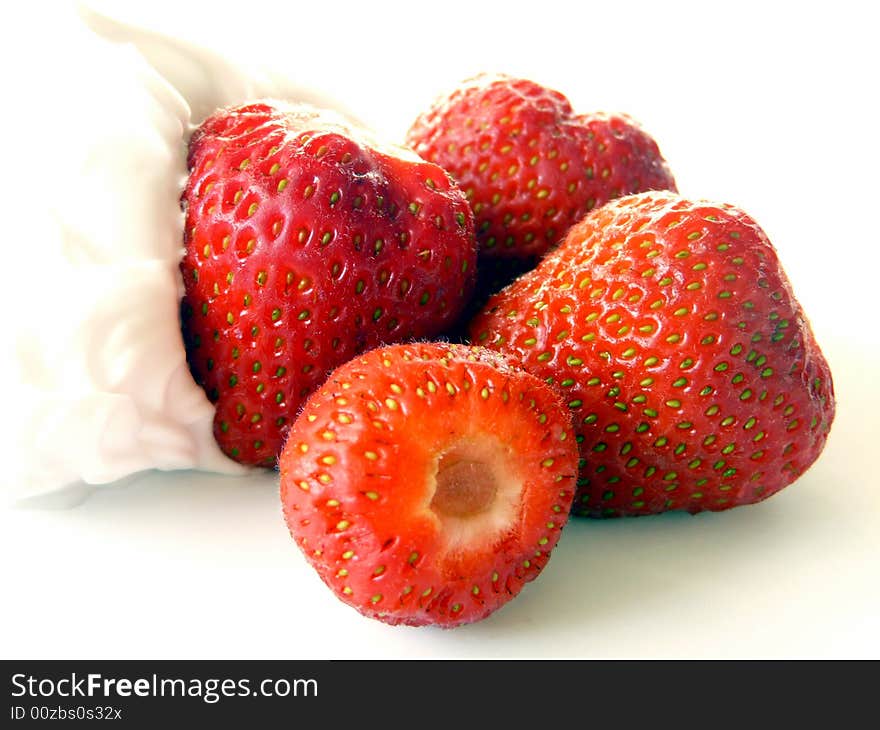 A close up of  sweet strawberries with lots of fresh cream. A close up of  sweet strawberries with lots of fresh cream