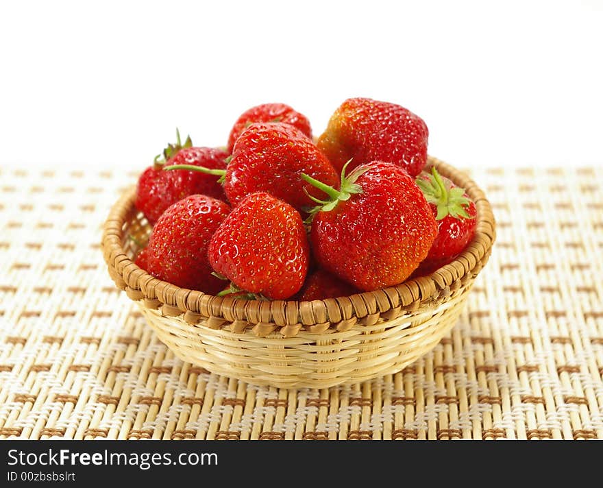 Ripe juicy strawberries in the braided basket. Ripe juicy strawberries in the braided basket