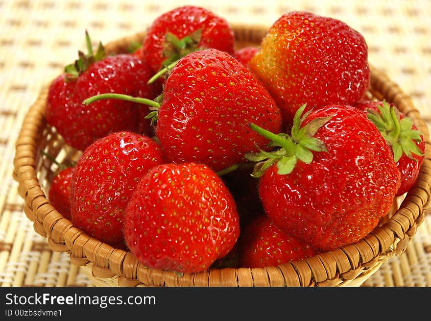 Ripe juicy strawberries in the braided basket