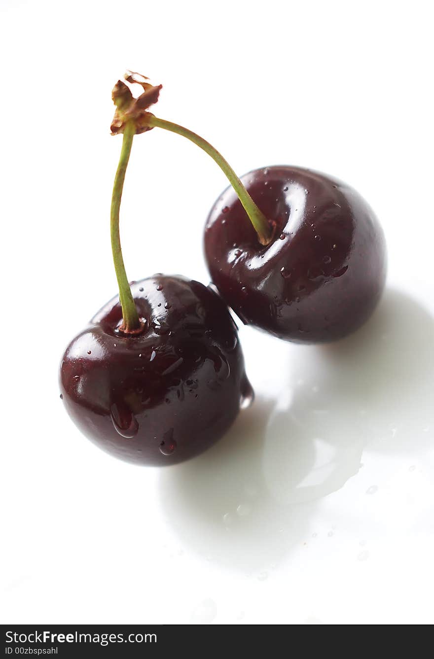 Two cherries with waterdrops isolated on white