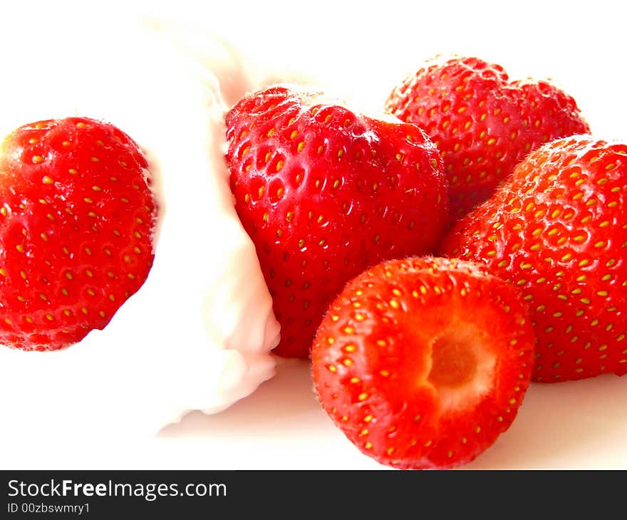 A close up of  sweet strawberries with lots of fresh cream. A close up of  sweet strawberries with lots of fresh cream