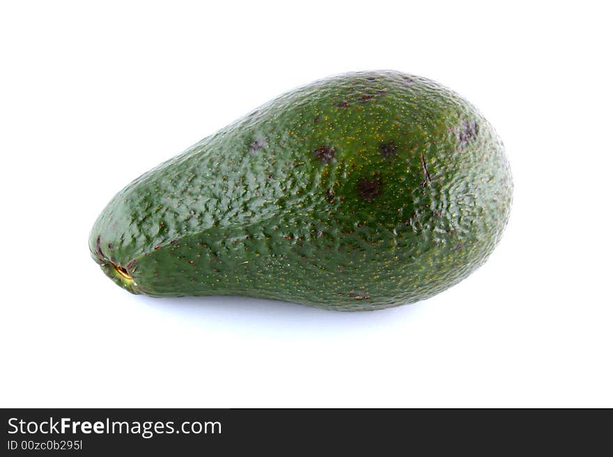 Intact avocado isolated on a white background.