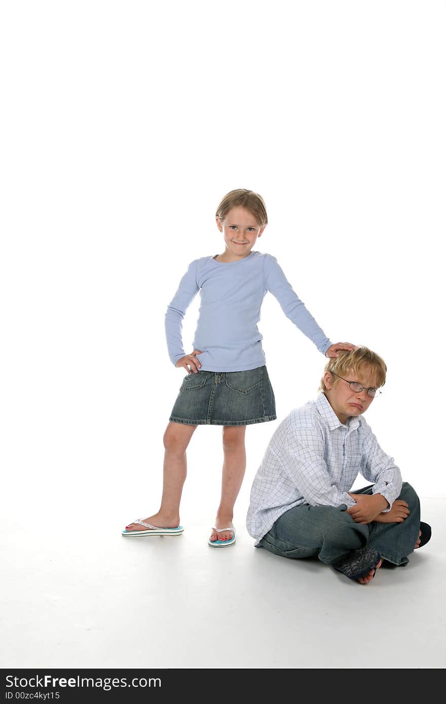 Girl putting her hand on her brother s head