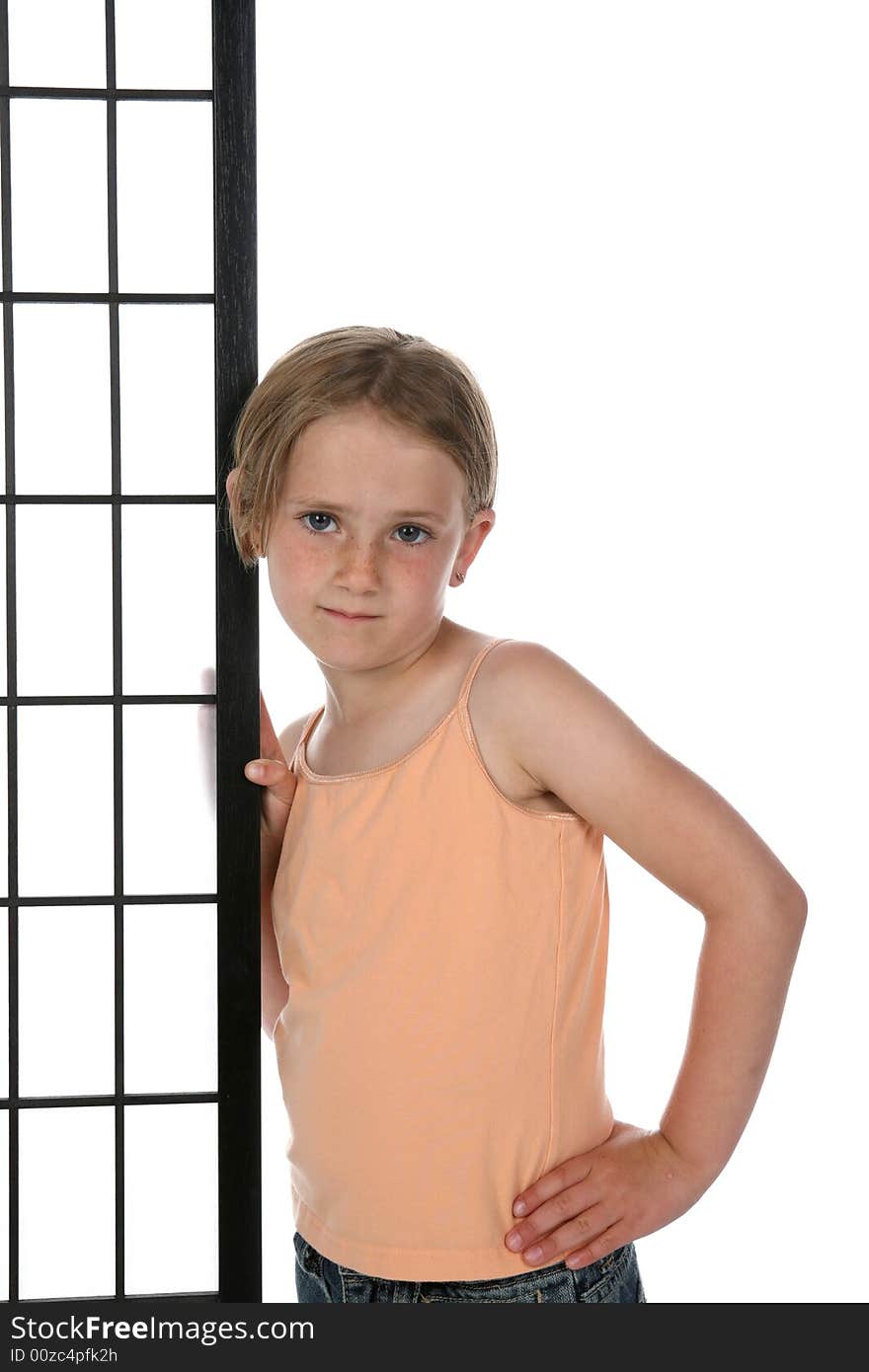 Girl in orange shirt standing next to a screen with grids