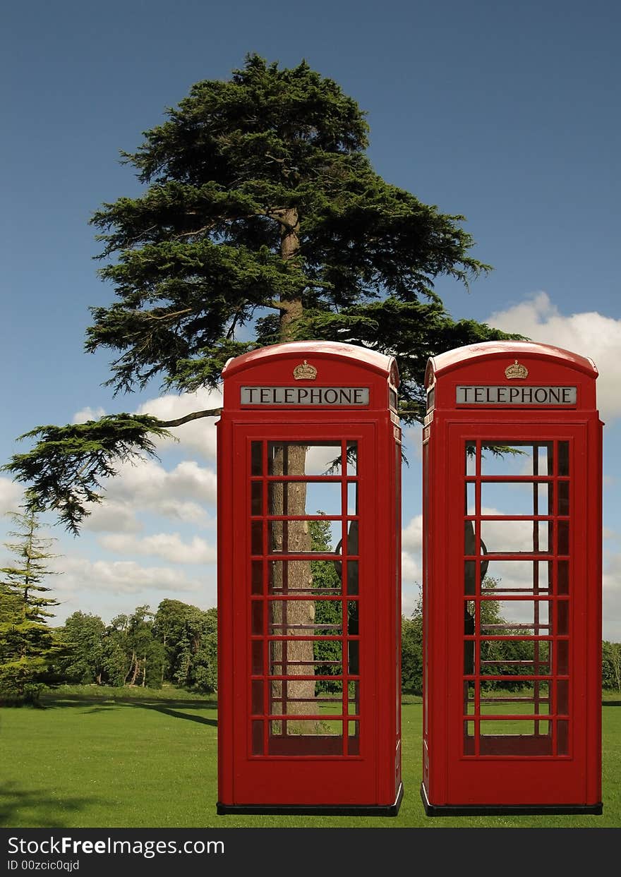 Two red phone boxes in the park. Two red phone boxes in the park