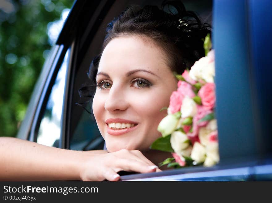 Beautiful bride with flowers in the car. Beautiful bride with flowers in the car