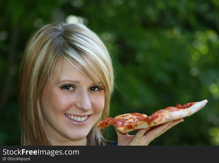 Girl eating pizza slice