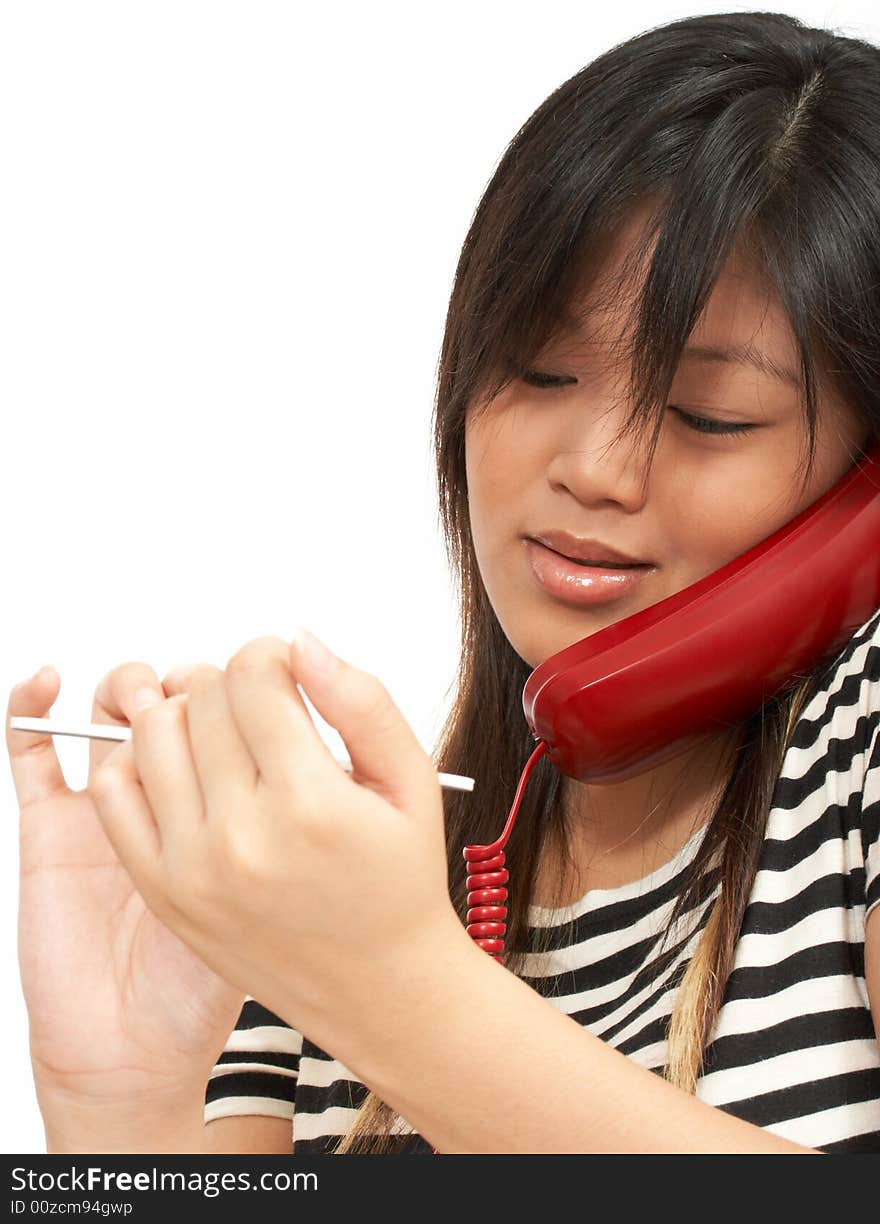 A  woman doing her nails while talking on the phone. A  woman doing her nails while talking on the phone